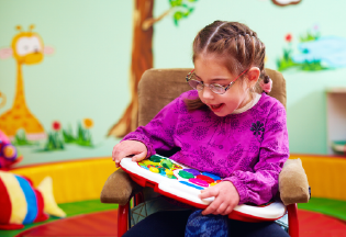 Girl in chair with a toy