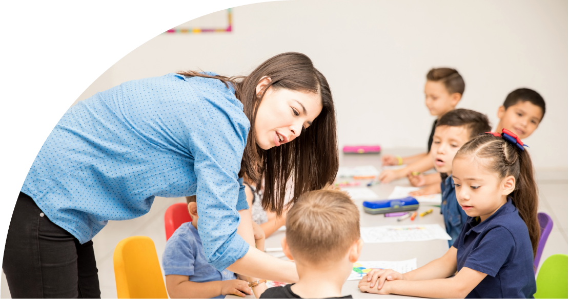 Woman teaching young children at a table